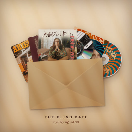 The Blind Date: five of Arielle's CDs fanned behind a kraft envelope. Mystery signed CD.